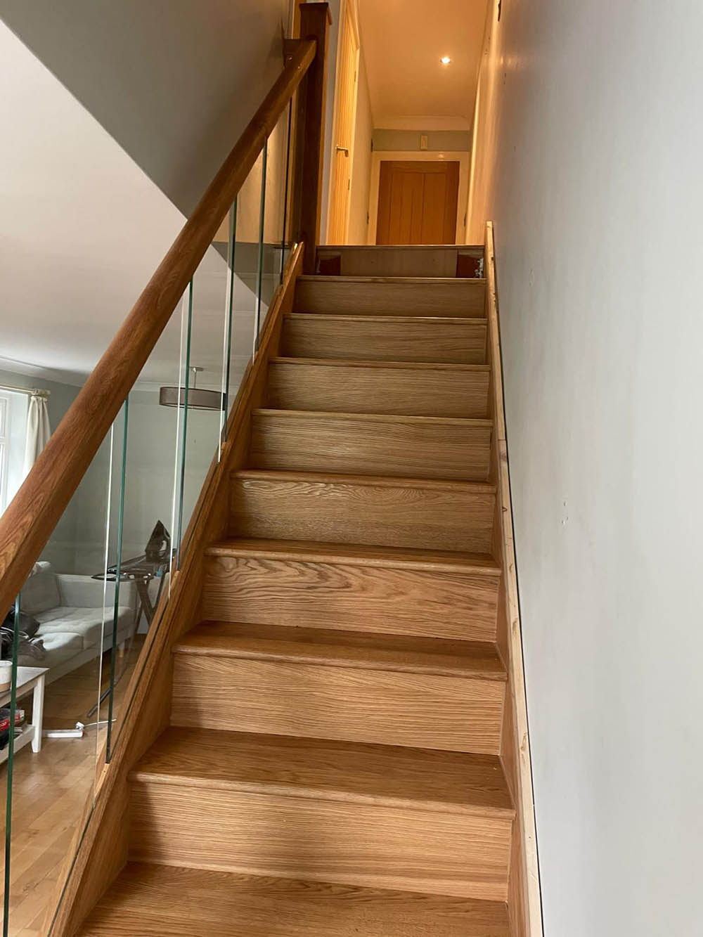Wooden staircase with glass panels
