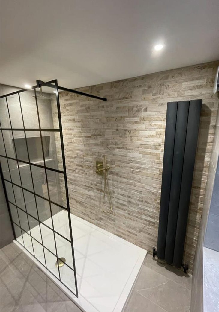 Black radiator and shower with gold accents