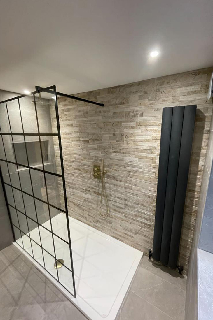 Black radiator and shower with gold accents