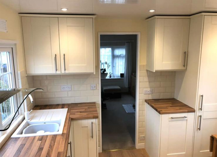 white kitchen sink and cupboards